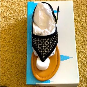 Black sandal with gold accents